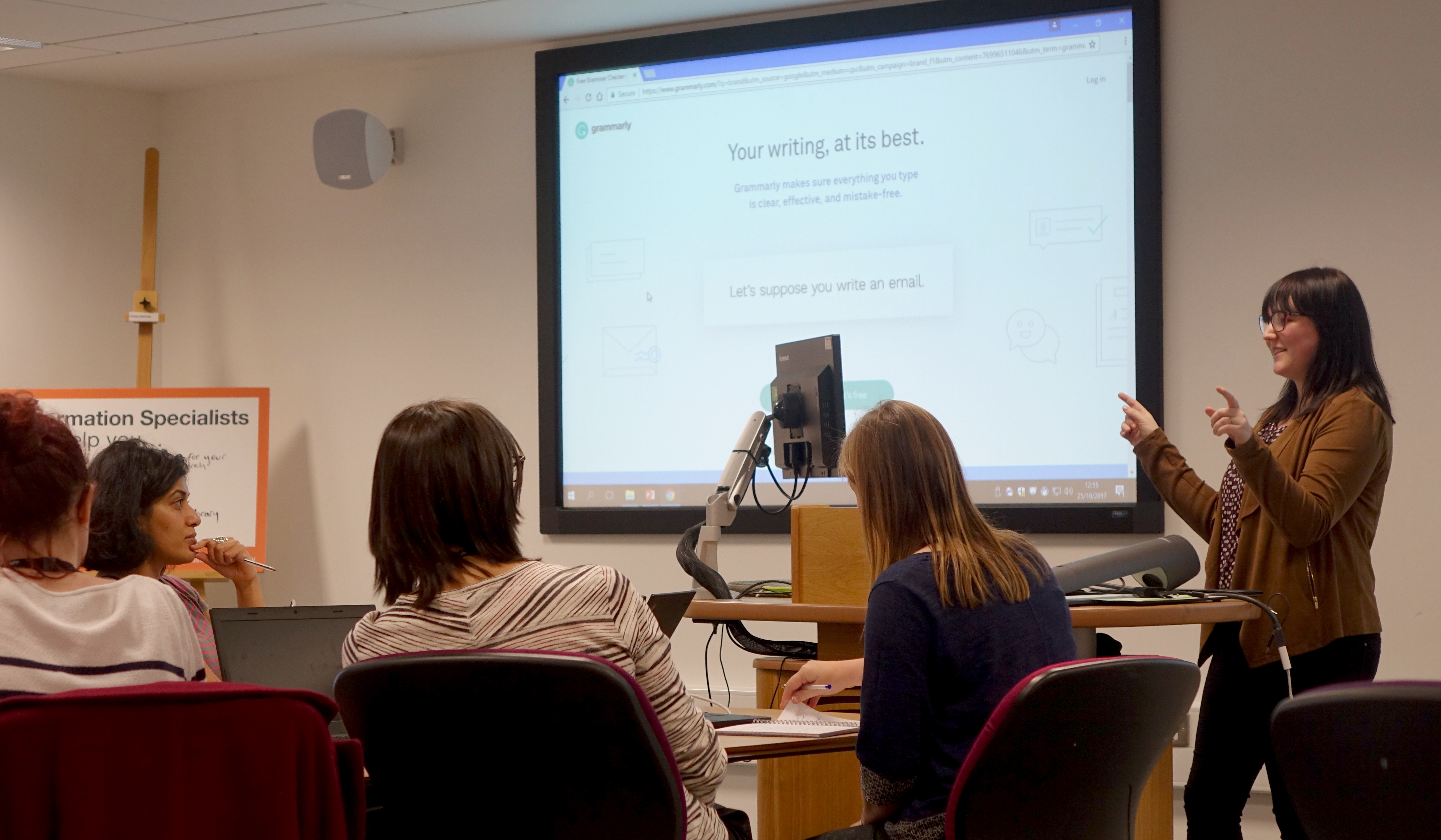 An AbilityNet member of staff giving a presentation in front of university staff