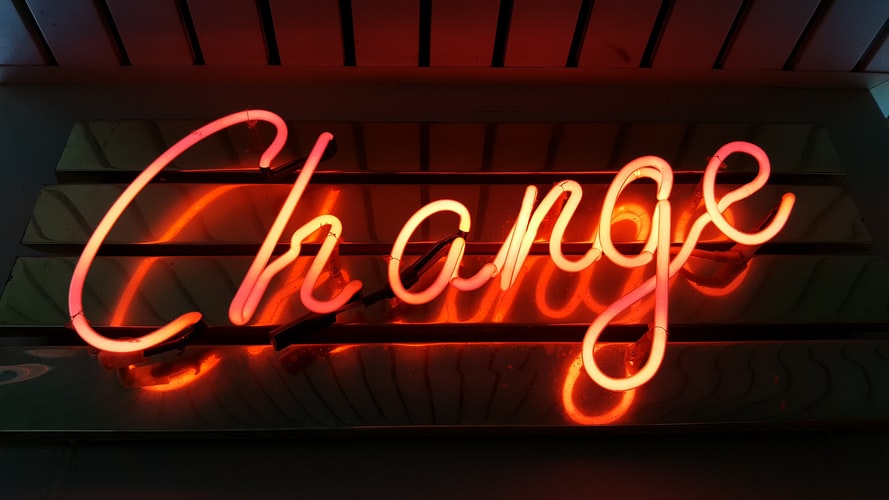 Image of a neon light spelling the word "change"