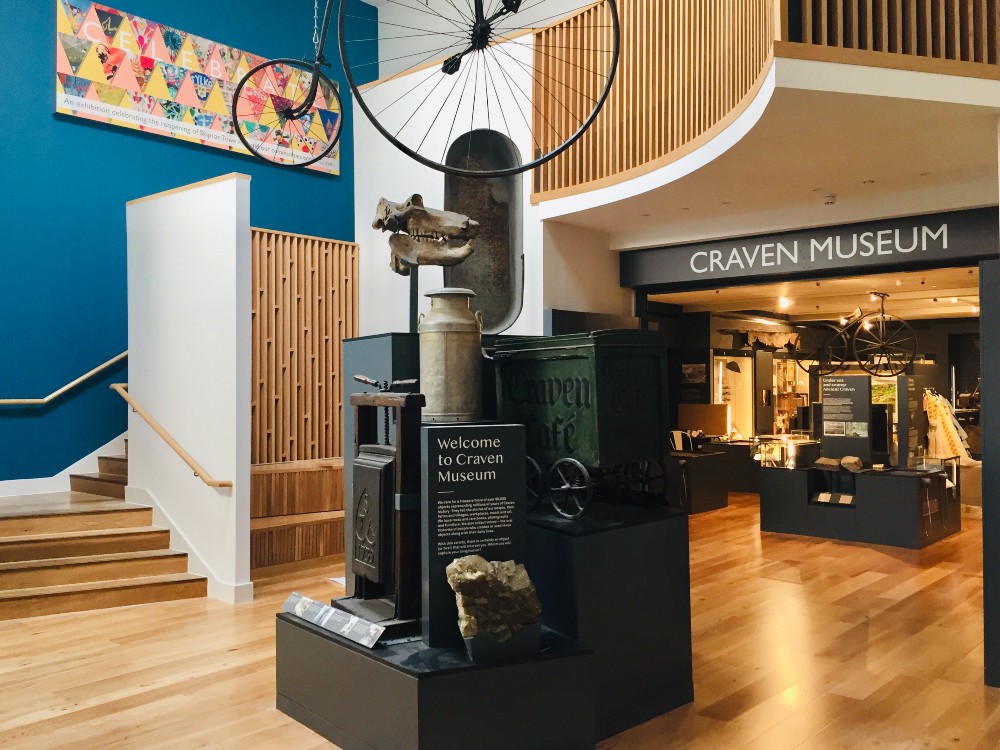 Craven Museum and Gallery foyer showing a penny farthing bicycle in a wooden room with shiny steps