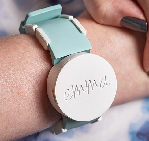 A person's wrist with the Emma watch being worn