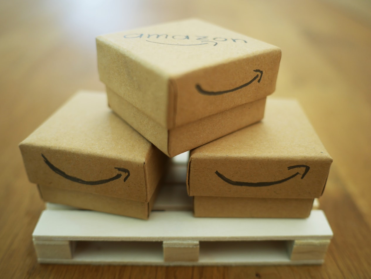 Cardboard boxes stacked up with Amazon smile logo