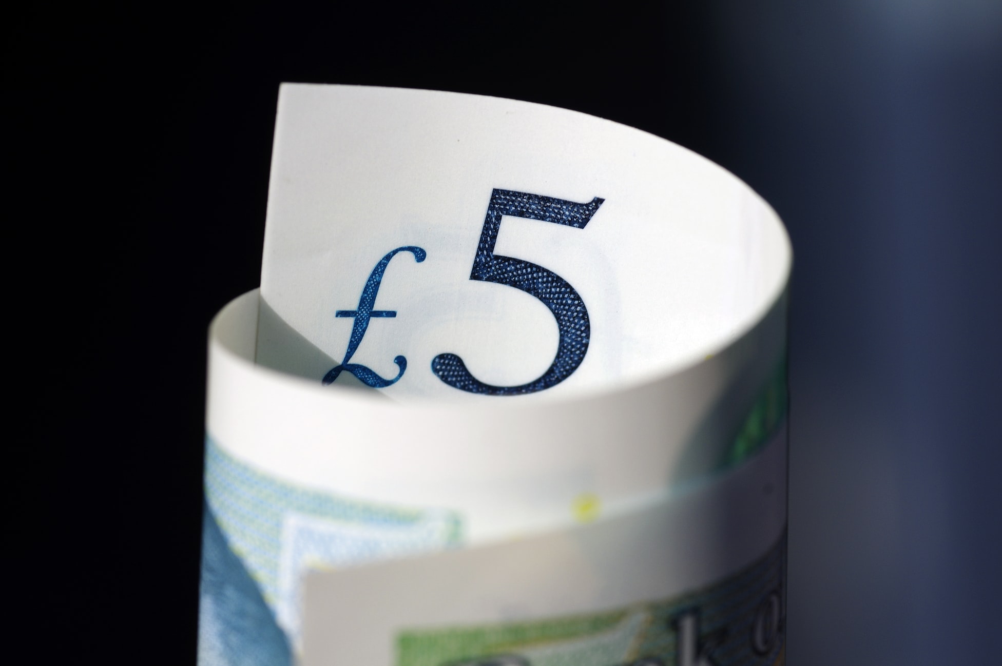 Picture of a rolled five pound note