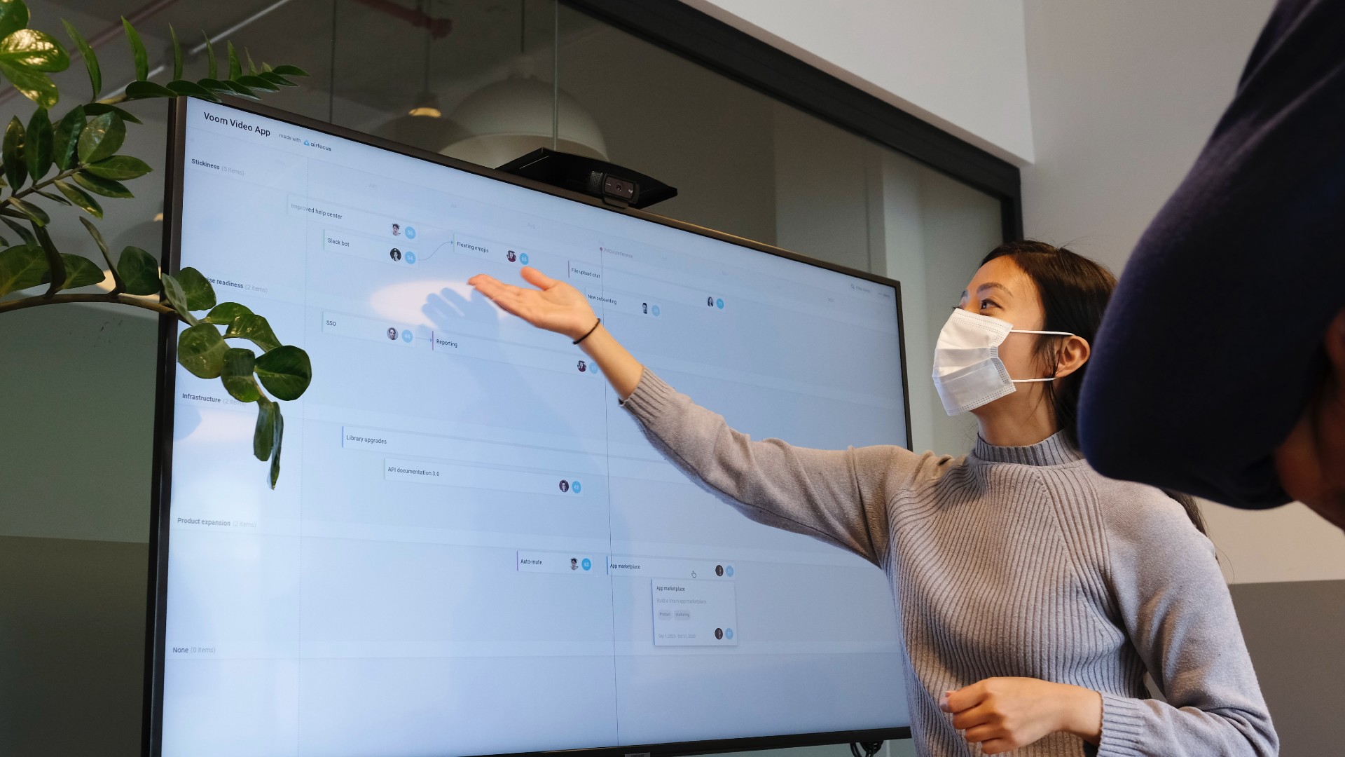 Woman in mask teaching at whiteboard